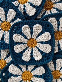 crocheted coasters with yellow and white flowers on them