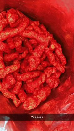 a red bag filled with food sitting on top of a table