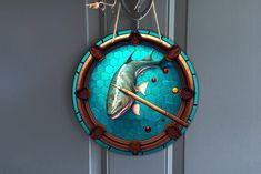 a stained glass clock with a fish on it