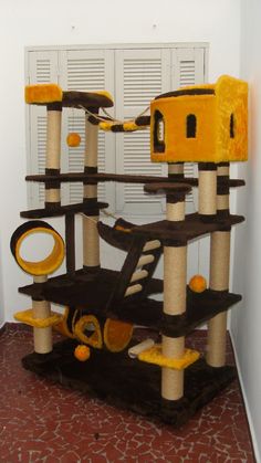 a cat tree with several cats on it in a room that has white walls and red carpet