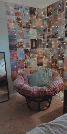 a room with a bed, mirror and pictures on the wall behind it that is covered in lights