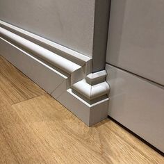 a close up of a door frame on a wooden floor