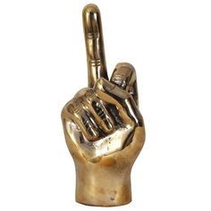 a gold colored statue of a hand making the peace sign