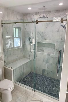 a bathroom with a walk in shower next to a toilet