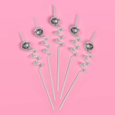 four silver candy lollipops on a pink background