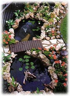 an image of a small pond in the middle of some rocks and water lilies