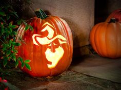 two carved pumpkins sitting next to each other