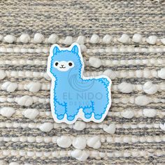 a blue llama sticker sitting on top of a rug