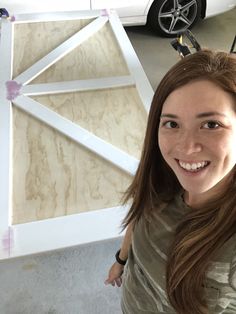 a woman standing in front of a white barn door