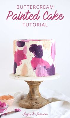 a white cake with pink and purple icing