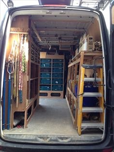 the back end of a van filled with lots of shelves and tools on it's sides