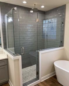 a bathroom with a tub, shower and sink