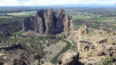 an aerial view of the rocky landscape and river in the distance with mountains in the background