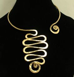 "This Open Collar Asymmetrical Necklace necklace is a Hand Hammered work of art. It will be the easiest necklace that you've ever put on in your life. Just slightly pull apart a few inches, slide it around your neck with a single hand and gently push it back to a comfy position. There are no clasps, no hooks, no connections. Be the envy, the talk of the town and stand out with this unique one of a kind body art. This is guaranteed comfort and be sure to get ready for lots of compliments. This is Unique Freeform Gold Necklace, Modern Jewelry With Unique Spiral Design, Elegant Spiral Jewelry With Unique Design, Unique Gold Swirl Jewelry, Unique Swirl Shaped Gold Jewelry, Unique Swirl-shaped Gold Jewelry, Adjustable Spiral Gold Necklace, Adjustable Gold Spiral Necklace, Elegant Spiral Necklaces For Jewelry Making