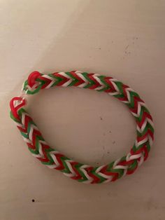 a red, white and green bracelet on a table