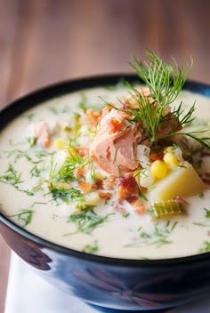 a bowl filled with soup and garnish on top of a table