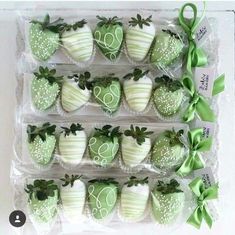 some green and white decorated strawberries in plastic bags