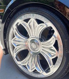 the front wheel of a car with chrome spokes