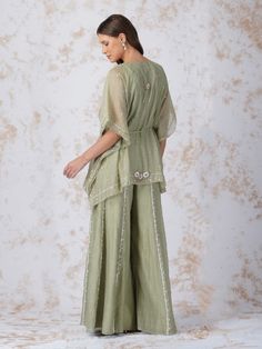 Semi Sheer Short Kaftan is embellished with threads, beads and crystals. It is paired with sequin detailed sharara and comes with a slip. Color: Sage Green Fabric: Chanderi Note: Wash Care - Dry Clean only The product will be delivered within 3-4 weeks of order placed Relaxed Fit Kurta And Sharara Set, V Neck Kaftan, Kurta And Sharara, Kaftan Kurta, Zardozi Work, Short Kaftan, Sharara Set, Green Fabric, Bridal Wear