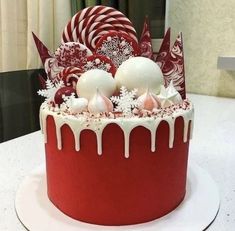 a red cake with white frosting and candy canes