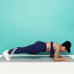 a woman is doing push ups on her stomach