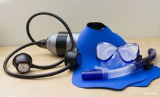 a scuba mask, snorkels and breathing apparatus on a table