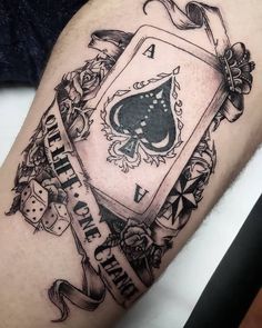 a black and white tattoo with a playing card on it