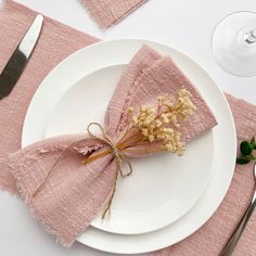 a white plate topped with two pink napkins