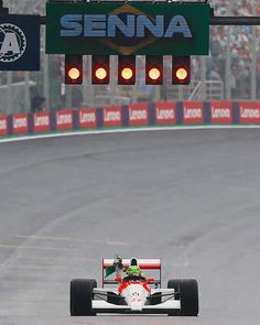 a man driving a racing car on a race track