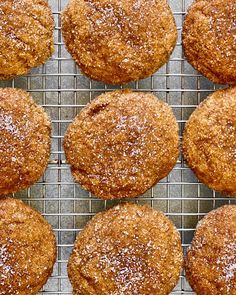 freshly baked muffins on a cooling rack with powdered sugar sprinkled on top