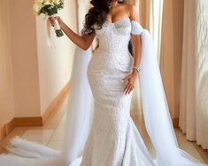 a woman in a wedding dress holding flowers