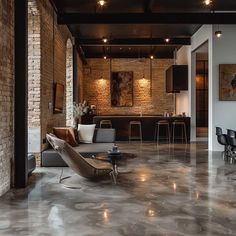 an industrial style living room with exposed brick walls and floor to ceiling windows that overlook the bar area