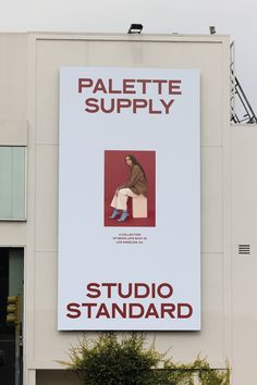 a large sign on the side of a building that says, palette supply studio standard