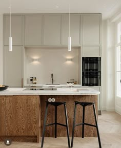 two stools are in front of the kitchen island