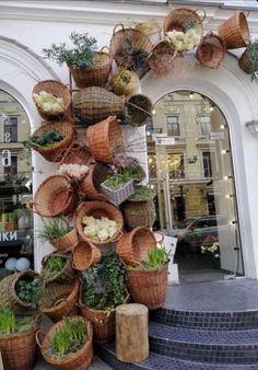 several baskets are stacked on top of each other in front of a building with steps leading up to it