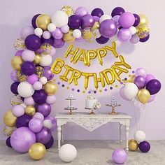 a purple and gold birthday party with balloons