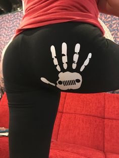 a person wearing black leggings with white hand prints on the bottom of their pants