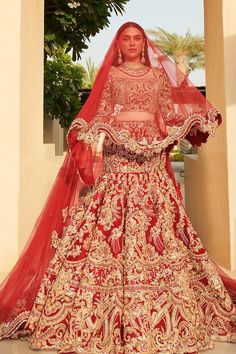 a woman in a red and gold bridal gown