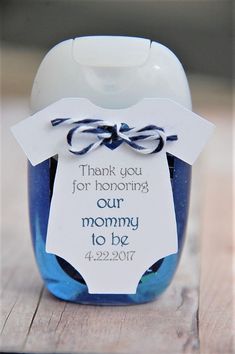 a blue jar with a tag on it that says thank you for honoring our mommy to be