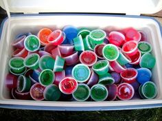 there are many different colored cups in the container