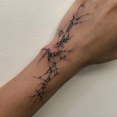 a person's arm with a tattoo on it that has barbed wire all over it