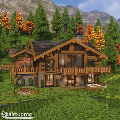 a large wooden house in the middle of a lush green field with trees and mountains behind it