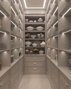 an empty walk in closet filled with lots of white dishes and vases on shelves