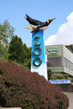 a large sign with two birds on top of it