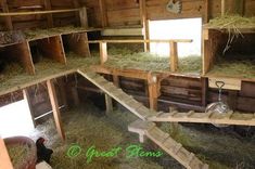 a barn filled with lots of hay and wooden stairs leading to the second floor area