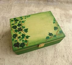 a green box with vines painted on it