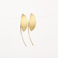 Unique minimalist solid 14k gold earrings. These marquise drop earrings are handcrafted of yellow 14k solid gold. They have a brushed finish with smooth shiny edges. They are lightweight and comfortable. These geometric earrings will add a chic touch of gold to your appearance. They are perfect for everyday wear and will add a refined and stylish look when combined with elegant night wear. A great gift for someone you love, or a treat for yourself. Silicone cups are included for safety. Earring' Modern 14k Gold Ear Climbers As Gift, Modern 14k Yellow Gold Ear Climbers, Modern Yellow Gold Ear Climbers As Gift, Modern Yellow Gold Ear Climbers For Gifts, Modern Yellow Gold Ear Climbers Gift, Modern Pierced Yellow Gold Ear Climbers, Modern Yellow Gold Pierced Ear Climbers, Contemporary Teardrop Yellow Gold Earrings, Contemporary Yellow Gold Teardrop Earrings