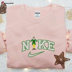 Introducing the Buddy Elf x Nike Embroidered Shirt, a must-have for every Christmas movie enthusiast! This limited edition shirt combines the iconic Buddy Elf character with the renowned Nike quality. Made from premium cotton, it offers unbeatable comfort and durability. The intricate embroidery adds a touch of whimsical charm, making it a standout piece. Perfect for spreading holiday cheer, this shirt is a unique gift for family and friends. Grab yours now and celebrate the season in style! Get Disney Nike Top, Custom Nike Crewneck Disney, Cartoon Nike Hoodie, Nike Vintage Sweatshirt Stitch, Costumized Nike Sweatshirts, Pull Nike Stitch, Jorgen Von Strangle, Nike Cartoon, Nike Inspired