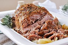 roast beef with herbs and potatoes in a white dish