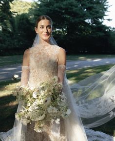 a woman in a wedding dress holding a bouquet